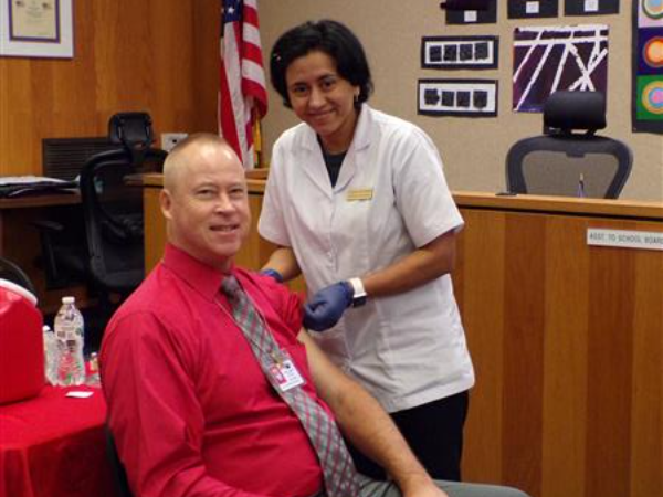 Superintendent Andrew gets a flu shot at the 2023 Wellness Workshop